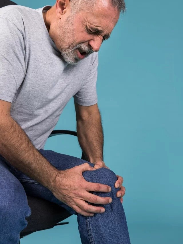 cropped-man-with-knee-pain-sitting-chair-scaled-1