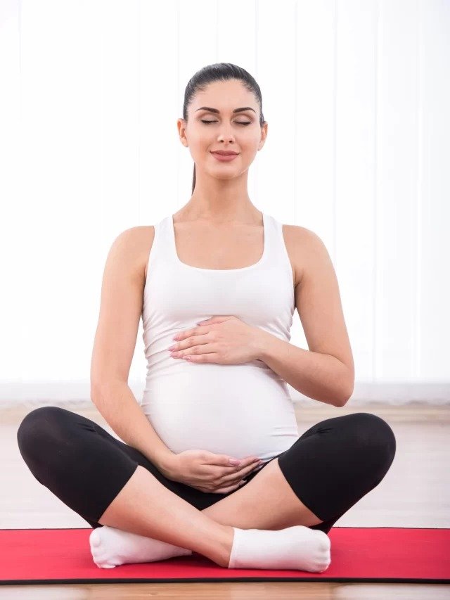 cropped-pregnant-woman-is-doing-yoga-exercise-scaled-1